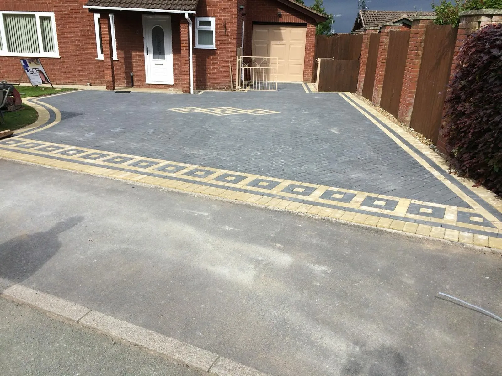 Grey and cream patterned block paving