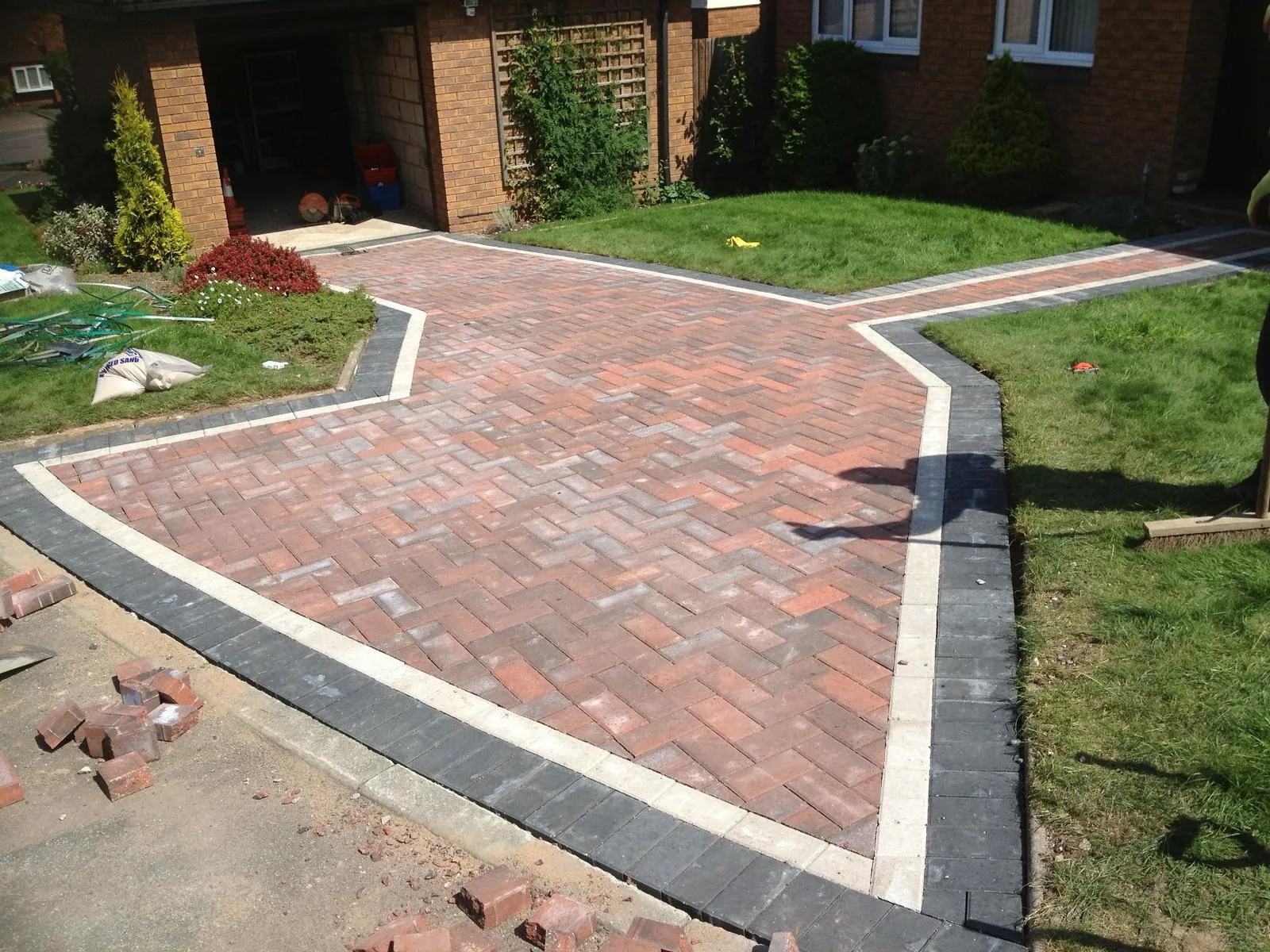 Paved front drive with adjoining patio