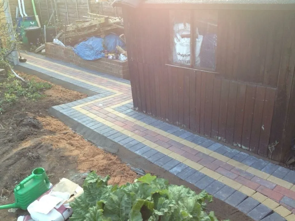 Block paved side path with decorative design